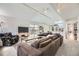 Bright living room featuring a large sectional sofa, sliding glass doors and open access to kitchen at 6267 S Albion Ct, Centennial, CO 80121