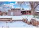 Spacious backyard with detached workshop and snow-covered lawn at 4865 Scranton Ct, Denver, CO 80239