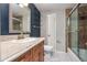 Updated bathroom with a walk-in shower and granite vanity at 4865 Scranton Ct, Denver, CO 80239