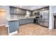 Modern kitchen with gray cabinets, granite counters, and stainless steel appliances at 4865 Scranton Ct, Denver, CO 80239