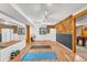 Finished basement gym/multipurpose area with mirrors, cork walls, wood flooring, carpeted area, and natural light at 32217 Buffalo Park Rd, Evergreen, CO 80439