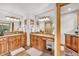 Bright bathroom with double vanity, stone countertops, and glass shower enclosure at 32217 Buffalo Park Rd, Evergreen, CO 80439