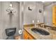 Elegant powder room featuring granite counters, a black vessel sink, and stylish rustic decor at 32217 Buffalo Park Rd, Evergreen, CO 80439