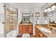 A spacious bathroom with double vanities, wooden cabinets, and a tiled walk-in shower at 32217 Buffalo Park Rd, Evergreen, CO 80439