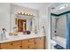 Bright bathroom features a double sink vanity, framed mirror, and a shower and tub at 32217 Buffalo Park Rd, Evergreen, CO 80439