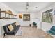 Bright bedroom features a futon, built-in desk, shelves, large windows providing natural light, and neutral tones at 32217 Buffalo Park Rd, Evergreen, CO 80439