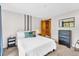 Bright bedroom featuring a queen bed, dresser, and wood framed decor at 32217 Buffalo Park Rd, Evergreen, CO 80439