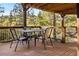Outdoor deck with wood flooring and railings showcasing metal table and chairs at 32217 Buffalo Park Rd, Evergreen, CO 80439