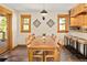 Inviting dining room with wood table, beams, and windows providing natural light and a cozy atmosphere at 32217 Buffalo Park Rd, Evergreen, CO 80439