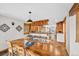 Bright dining area featuring wood accents, table with seating, and views into the kitchen at 32217 Buffalo Park Rd, Evergreen, CO 80439
