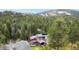 Stunning mountain home nestled amongst tall evergreen trees offering seclusion and scenic views at 32217 Buffalo Park Rd, Evergreen, CO 80439