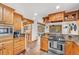Well-equipped kitchen featuring stainless steel appliances, tile backsplash, and wood cabinetry at 32217 Buffalo Park Rd, Evergreen, CO 80439