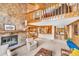 Spacious living room featuring a stone fireplace and an open floor plan with beautiful wooden accents at 32217 Buffalo Park Rd, Evergreen, CO 80439