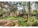 The lush backyard offers a relaxing setting with grass, garden beds, trees, and fence lines at 1438 Stockton Dr, Erie, CO 80516