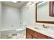 Bright bathroom featuring tile flooring, a tub and shower combination, and a wood vanity with a sink at 1438 Stockton Dr, Erie, CO 80516