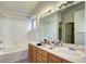 Bathroom featuring dual sinks, lots of counter space, and a shower/tub combo at 1438 Stockton Dr, Erie, CO 80516