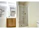 Bathroom showcasing a glass-enclosed shower and updated vanity with ample lighting at 1438 Stockton Dr, Erie, CO 80516