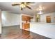 Cozy kitchen with wooden cabinets, breakfast bar, and view into the dining and living areas at 1438 Stockton Dr, Erie, CO 80516