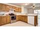 The kitchen features wood cabinets, tile floors, and stainless steel appliances at 1438 Stockton Dr, Erie, CO 80516