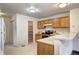 Functional kitchen with wood cabinets and an adjoining pantry for ample storage solutions at 1438 Stockton Dr, Erie, CO 80516