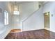 Bright living room with hardwood floors, a high ceiling, and a modern staircase at 1438 Stockton Dr, Erie, CO 80516