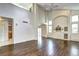 Open-concept living room with a vaulted ceiling, hardwood floors, and a view of the kitchen at 1438 Stockton Dr, Erie, CO 80516