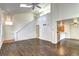 Open-concept living room with a vaulted ceiling, hardwood floors, and a view of the kitchen at 1438 Stockton Dr, Erie, CO 80516
