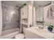 Well-lit bathroom features modern vanity, storage cabinet, and shower-over-tub with stylish tile surround at 1648 S Cole St # A2, Lakewood, CO 80228