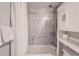 Bright bathroom showcases shower-over-tub with contemporary tile surround and convenient built-in storage at 1648 S Cole St # A2, Lakewood, CO 80228