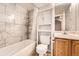 Beautiful bathroom with white-tiled shower/tub combo and wood-style floors at 1648 S Cole St # A2, Lakewood, CO 80228