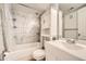 Full bathroom boasts shower and tub combination with updated tile and vanity at 1648 S Cole St # A2, Lakewood, CO 80228