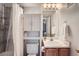 Bathroom with shower, vanity, lighting, and nearby door at 1648 S Cole St # A2, Lakewood, CO 80228