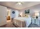 Cozy bedroom with a ceiling fan, painting, carpeted floors, and ensuite bathroom at 1648 S Cole St # A2, Lakewood, CO 80228