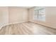 Bright bedroom featuring wood floors and a large arched window at 1648 S Cole St # A2, Lakewood, CO 80228