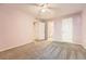 Bright bedroom features neutral carpet, a ceiling fan, and an ensuite bathroom at 1648 S Cole St # A2, Lakewood, CO 80228
