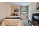 Bedroom with plush carpet, large windows, and a spacious closet at 1648 S Cole St # A2, Lakewood, CO 80228