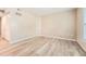 A spacious, empty bedroom with neutral walls, wood flooring, and a closet at 1648 S Cole St # A2, Lakewood, CO 80228