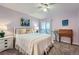 Well-lit bedroom with light-purple walls, carpeted floors, ceiling fan, and backyard access at 1648 S Cole St # A2, Lakewood, CO 80228