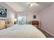 Bedroom featuring backyard access, carpeted floors, ceiling fan, desk, and painting at 1648 S Cole St # A2, Lakewood, CO 80228