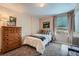 Cozy bedroom features plush carpet, large windows, and a classic wood dresser at 1648 S Cole St # A2, Lakewood, CO 80228
