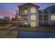 Exterior view of home featuring well-kept lawn, mature trees, staircase and multiple floors of living space at 1648 S Cole St # A2, Lakewood, CO 80228