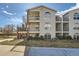 Well-manicured lawn and exterior of the home feature staircase and multiple floors of living space at 1648 S Cole St # A2, Lakewood, CO 80228