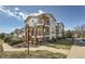 Multi-level condo building with brick accents, walkways and green space on a sunny day at 1648 S Cole St # A2, Lakewood, CO 80228