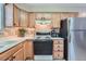 Well-equipped kitchen with light-colored countertops, wood cabinets and modern appliances at 1648 S Cole St # A2, Lakewood, CO 80228