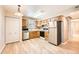 A well-lit kitchen featuring stainless steel appliances, wood cabinets and vinyl floors at 1648 S Cole St # A2, Lakewood, CO 80228