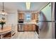 Bright eat-in kitchen features stainless steel appliances, and natural wood cabinetry at 1648 S Cole St # A2, Lakewood, CO 80228