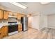 Eat-in kitchen boasts oak cabinets, stainless steel appliances, and modern flooring at 1648 S Cole St # A2, Lakewood, CO 80228