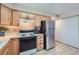 Functional kitchen with white countertops, stainless steel refrigerator and wood cabinets at 1648 S Cole St # A2, Lakewood, CO 80228