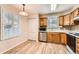 Inviting kitchen with stainless steel dishwasher and oak cabinetry at 1648 S Cole St # A2, Lakewood, CO 80228