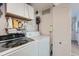 Functional laundry room with washer, dryer, overhead storage and convenient access to the home at 1648 S Cole St # A2, Lakewood, CO 80228